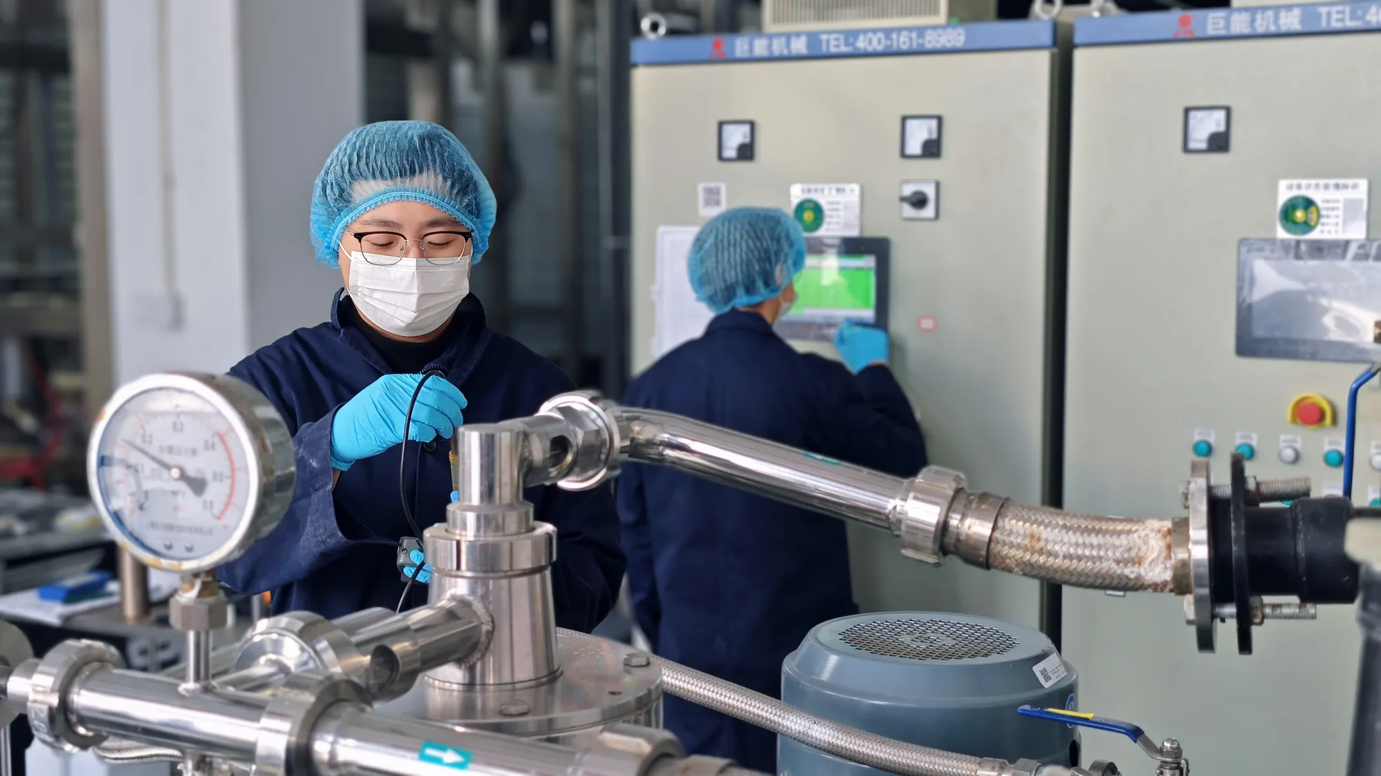 HETCHYN employee operates stainless-steel ingredient processing pipework